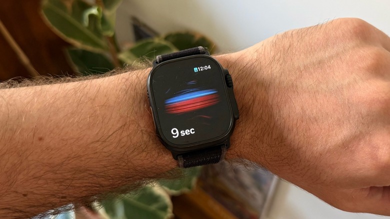 An Apple Watch Ultra measuring blood oxygen on a man's wrist