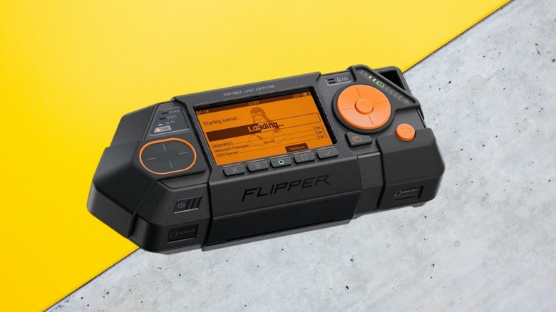 Flipper One on multi-color background with screen on.