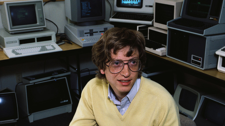 A young Bill Gates with computers behind him
