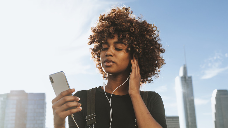 a woman listening to music on her phone