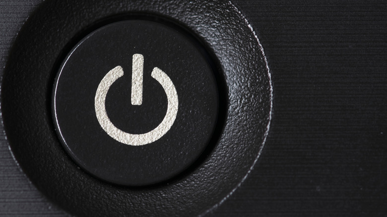Close up of a power button logo on a modern electronic device.