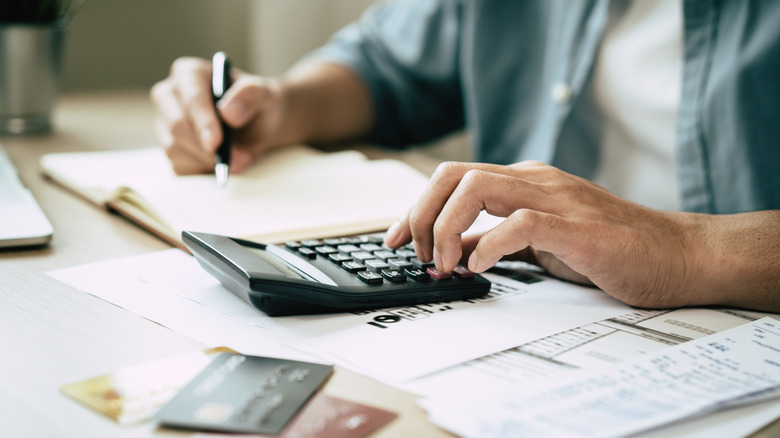 Close up of man calculating expenses