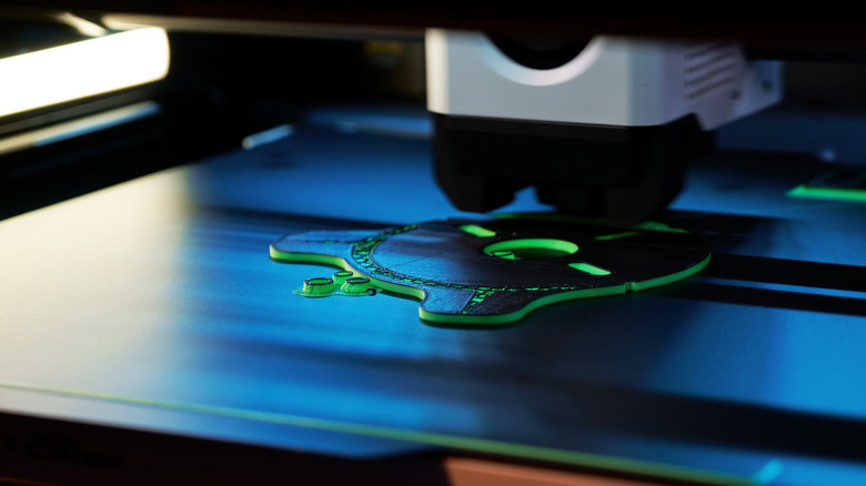 Close-up of 3D printer printing cog-type item