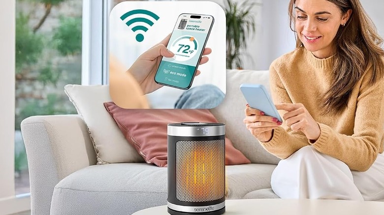 A woman controls a SereneLife smart heater using the SereneLife app on her phone.