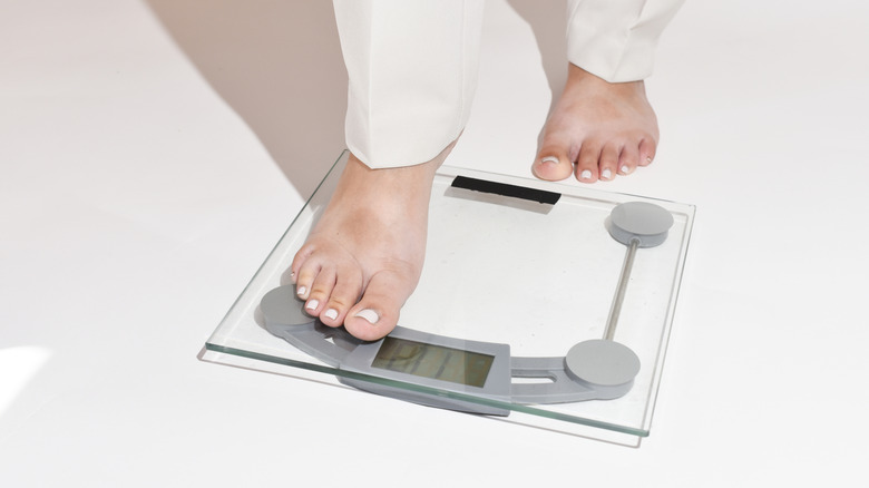 Person stepping on a smart scale.