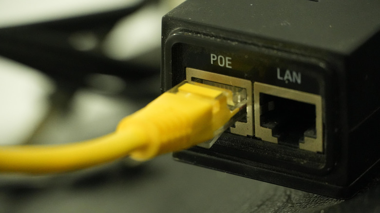 A yellow ethernet cable plugged into a router port labelled POE