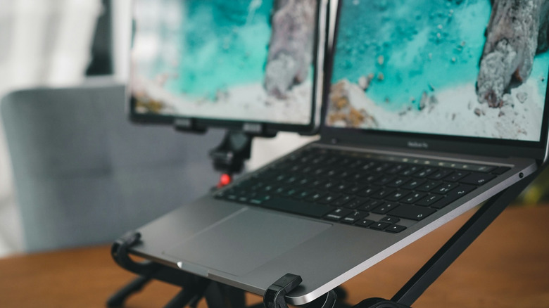 An Apple MacBook Pro connected to a portable monitor in one of the only clean stock photos we can find.