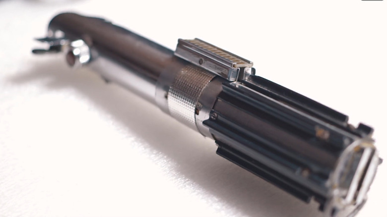 A close up of the original light saber from A New Hope