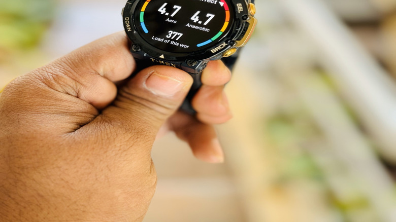 A person holding the Amazfit T-Rex smart watch