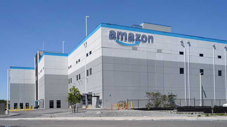 An exterior photograph of an Amazon warehouse.