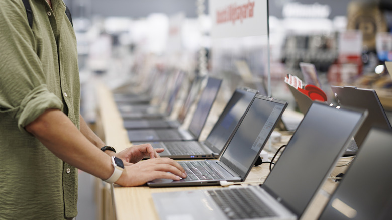 a man buying a laptop on a store