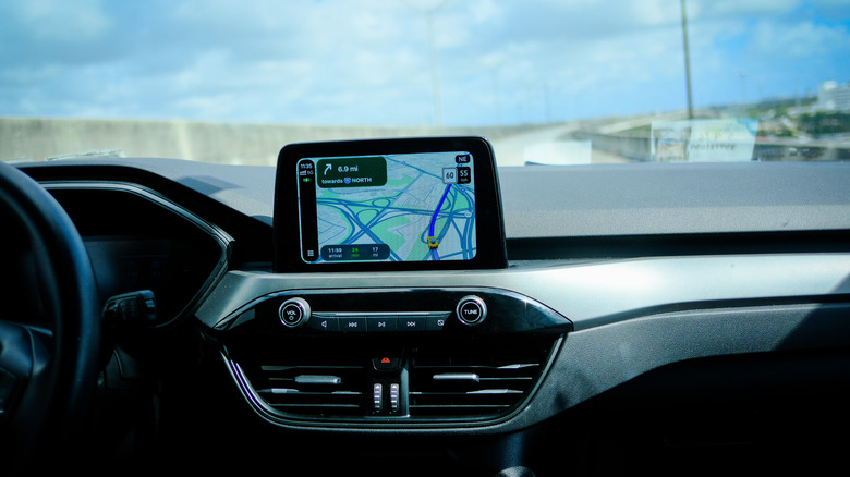 a screen on a car dashboard with Google Maps open giving driving directions