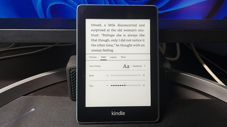 kindle placed against an external monitor showing the font settings for a book