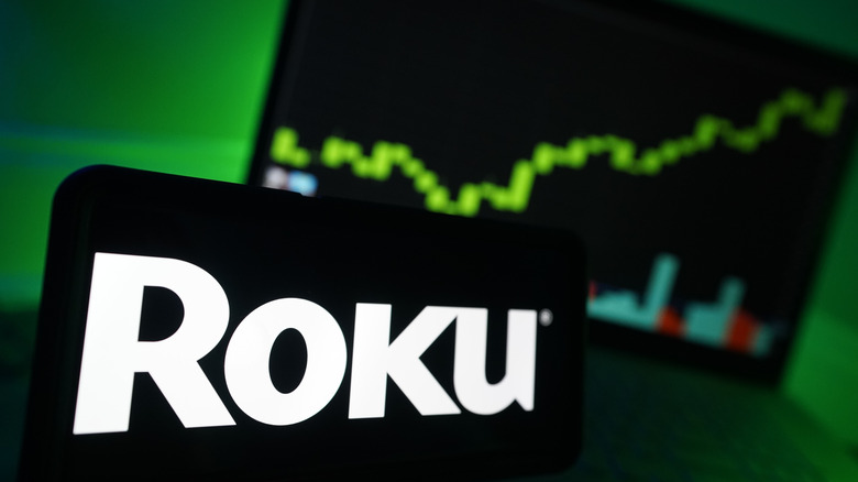Roku logo in foreground with green chart in background
