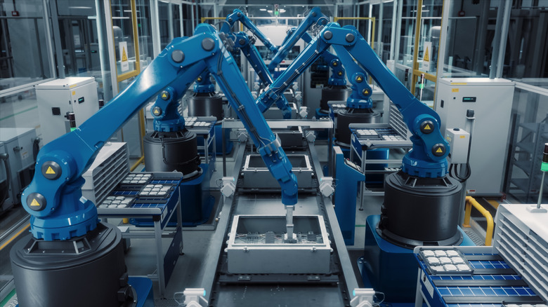 Robotic arms working on a factory assembly line
