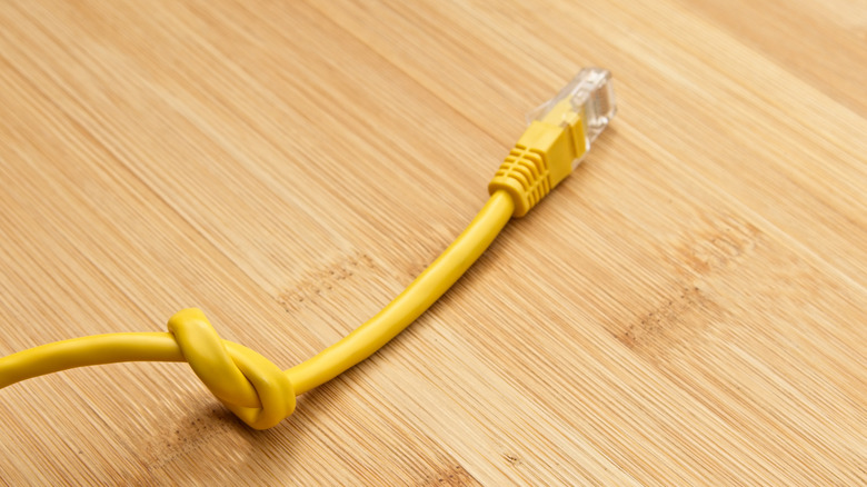 concept of data throttling, ethernet cable tied in a knot