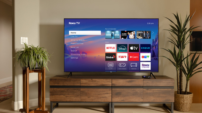 A Roku TV set up in a living room showing the menu screen.