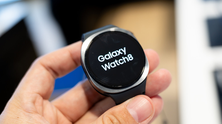 A hand holding the Samsung Galaxy Watch 8