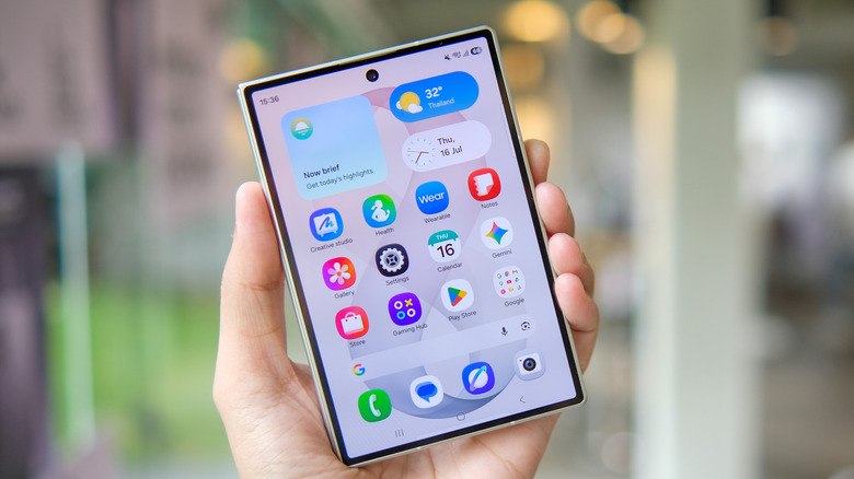 The Galaxy Z Fold 8 in hand, folded, with the cover screen turned on.