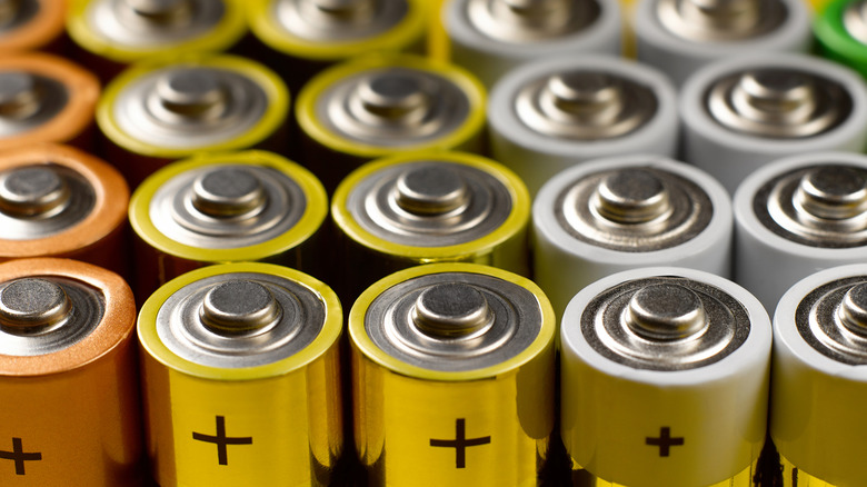 A stack of AA batteries, viewed from their positive-side