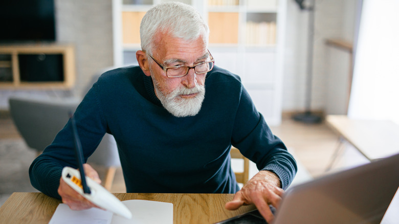 A man changing router settings on a computer