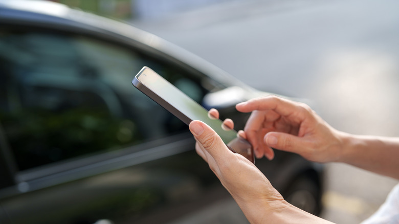 Using a smartphone to locate a car in a parking lot.