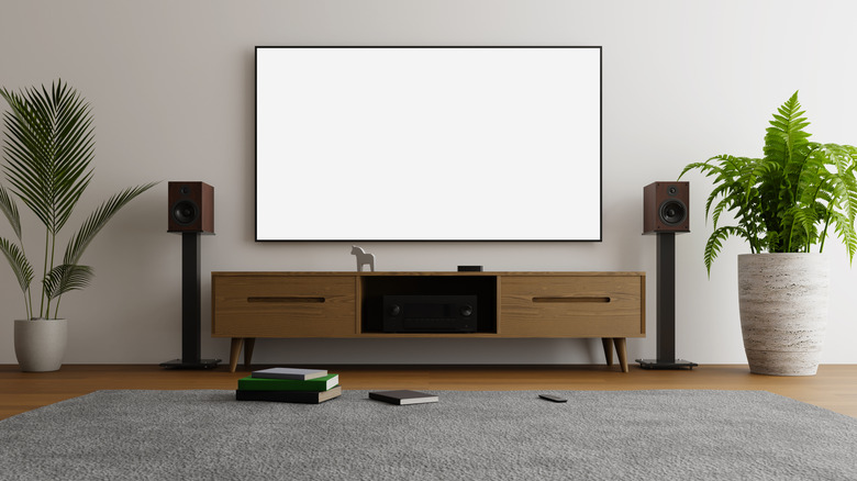 An entertainment center with a TV flanked by speakers on stands