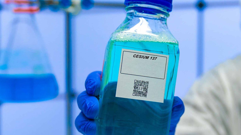 Image of a lab beaker containing Cesium 137