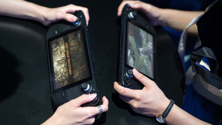Two people playing on two Steam Decks across from each other