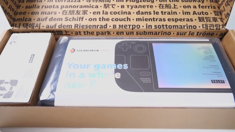 Unboxing the Steam Deck OLED in front of a white background