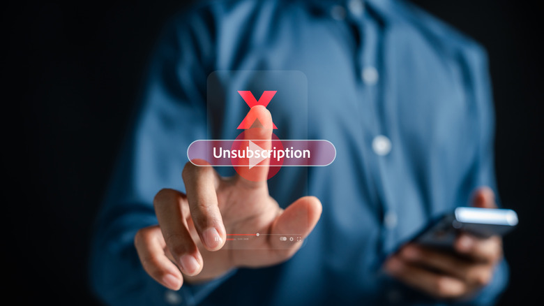 unsubscribing concept, person touching virtual unsubscribe button