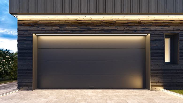 A garage door illuminated by various lights.