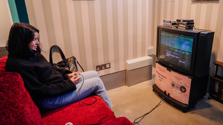 Person playing a retro video game on a CRT TV