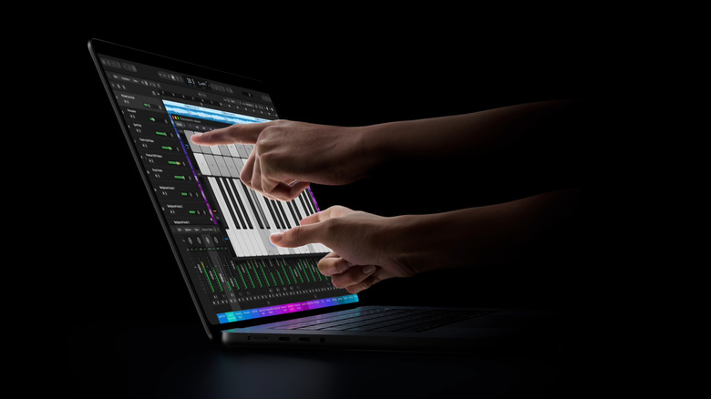 Fingers touching new MacBook Pro