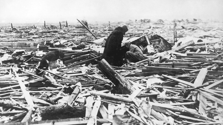 people looking through rubble from the tri-state tornado
