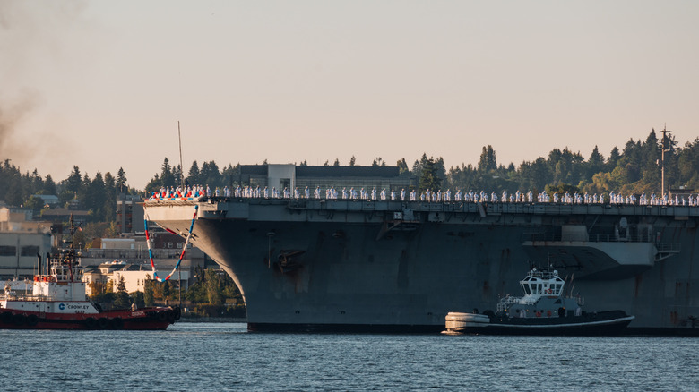 sailors on the deck of an aircraft carrier