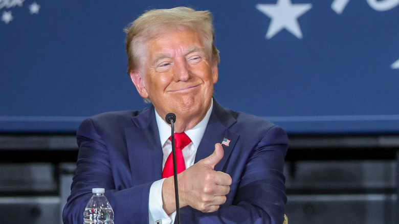 President Trump holding a thumbs up