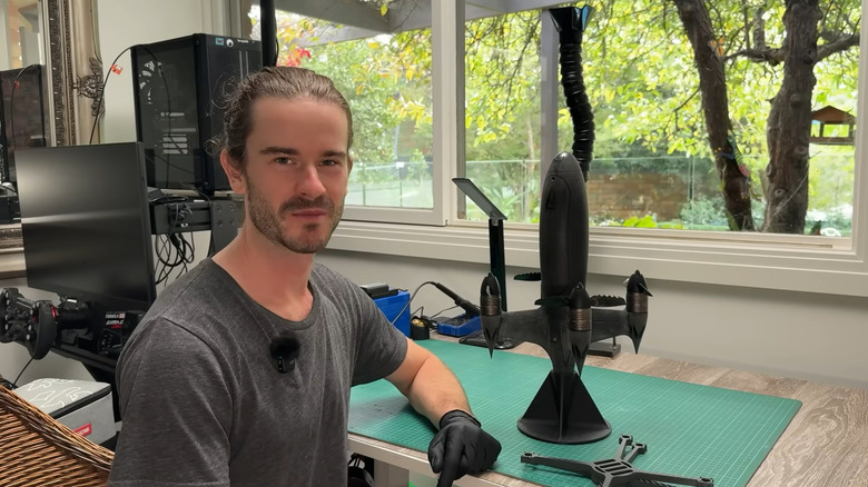 Ben Biggs sits besides their Blackbird drone, showcasing its serrated edges.