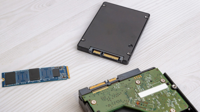 An M.2 SSD placed next to a SATA SSD and a hard disk drive