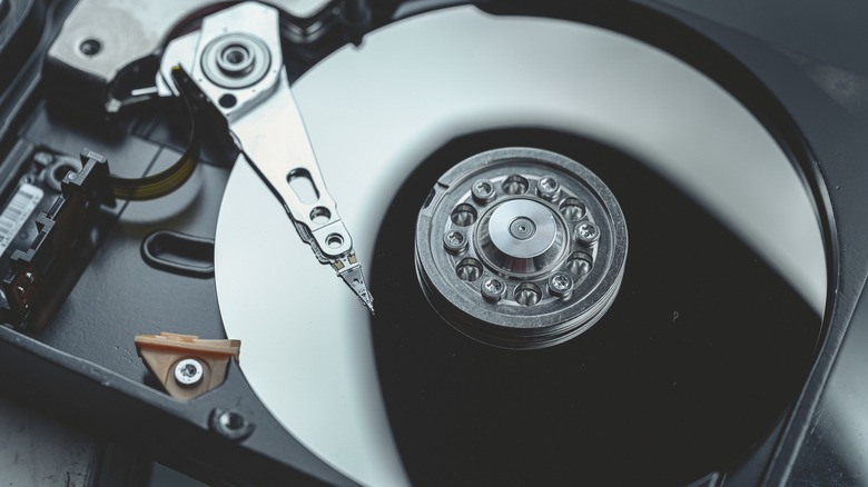 A hard disk drive with the disk and its reader uncovered