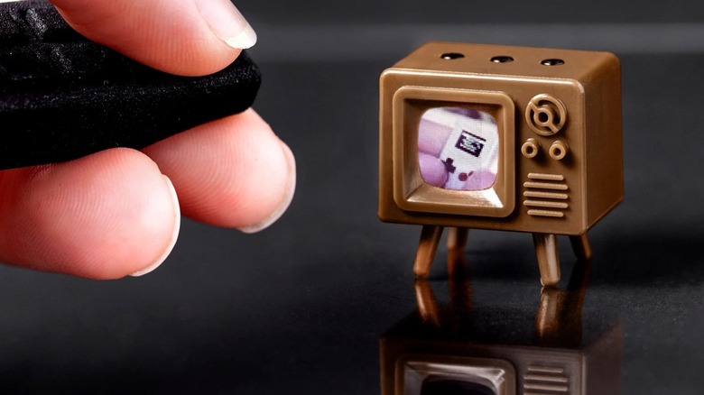 Tiny Circuits TinyTV Mini with remote in use.