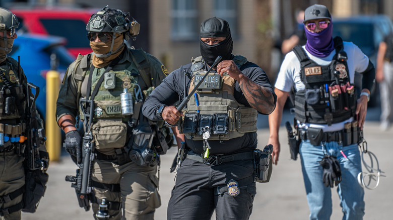 Border patrol police agents in tactical gear on the road