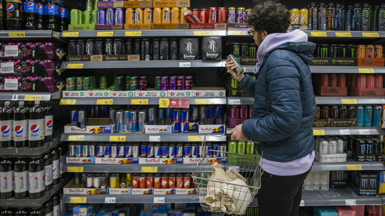 a man shops for energy drinks in a store