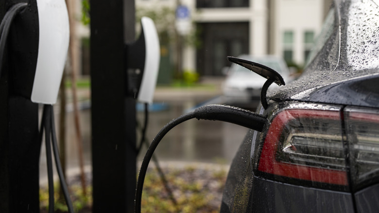 electric car being charged up in the rain