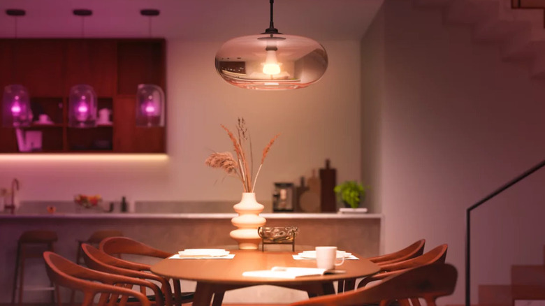 A Philips Hue smart bulb above a kitchen table