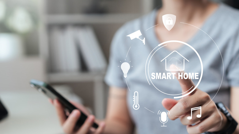 Person on phone touching an icon labeled Smart Home