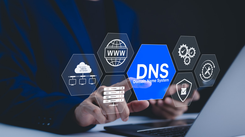 a person tapping on DNS next to a computer