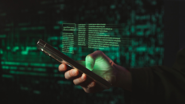 a person holding a smartphone against a background showing encryption and security imagery