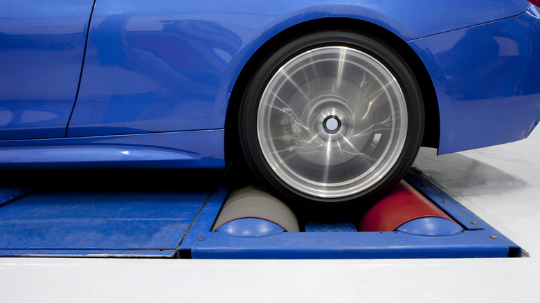 a blue car being tested on a dynamometer