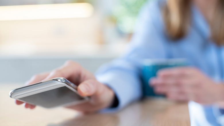 Person placing phone face down on table